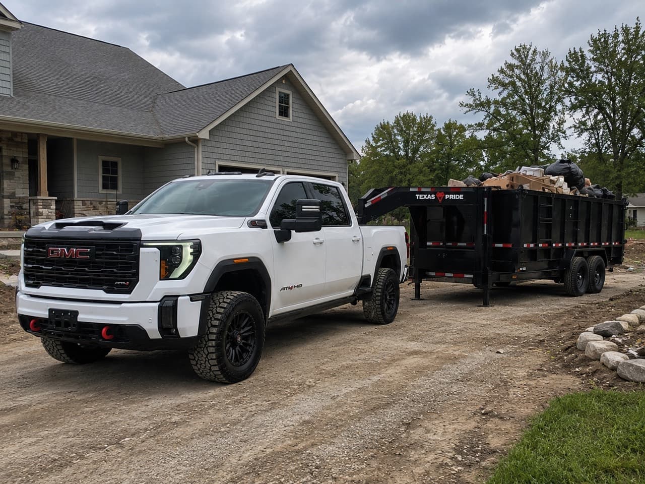 Smith's Property Services GMC 3500 with a roll-off dumpster at a residential cleanup